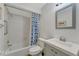 Well-lit bathroom features a tub/shower combo with stylish curtain and a vanity with integrated sink at 5705 Garden Lakes Majestic, Bradenton, FL 34203
