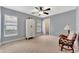 Serene bedroom with neutral walls, chair, and walk-in closet providing a comfortable and relaxing space at 5705 Garden Lakes Majestic, Bradenton, FL 34203