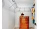 Organized walk-in closet featuring white shelving and a wooden dresser for efficient storage at 5705 Garden Lakes Majestic, Bradenton, FL 34203