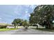 Scenic community entrance featuring dual signage and lush landscaping, creating an inviting welcome to Garden Lakes at 5705 Garden Lakes Majestic, Bradenton, FL 34203
