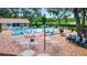 An inviting community pool with ample seating surrounded by lush greenery at 5705 Garden Lakes Majestic, Bradenton, FL 34203