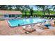 A well-maintained community pool with various seating options for residents at 5705 Garden Lakes Majestic, Bradenton, FL 34203