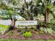 Community entrance sign for Garden Lakes, featuring lush landscaping and mature trees at 5705 Garden Lakes Majestic, Bradenton, FL 34203