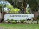 Entrance to Garden Lakes community, featuring landscaped gardens and brick pillars at 5705 Garden Lakes Majestic, Bradenton, FL 34203