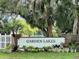 Landscaped sign for the Garden Lakes community with lush greenery and palm trees at 5705 Garden Lakes Majestic, Bradenton, FL 34203