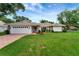 Single-Gathering home with a tile roof, green lawn, brick-accented front, and a two-car garage at 5705 Garden Lakes Majestic, Bradenton, FL 34203