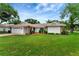 Charming single-story home with a tile roof, beautiful lawn, and a two-car garage at 5705 Garden Lakes Majestic, Bradenton, FL 34203