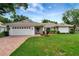 Charming single-story home featuring a well-manicured lawn, brick driveway, and a two-car garage at 5705 Garden Lakes Majestic, Bradenton, FL 34203