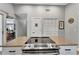 Granite island with smooth cooktop, stainless oven, and white cabinets, providing ample storage at 5705 Garden Lakes Majestic, Bradenton, FL 34203