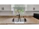 Stainless steel sink and faucet complement the elegant granite countertops and cabinetry in this modern kitchen at 5705 Garden Lakes Majestic, Bradenton, FL 34203