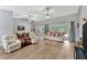 Expansive living area featuring vaulted ceiling, wood flooring, comfortable seating, and access to the lanai at 5705 Garden Lakes Majestic, Bradenton, FL 34203