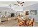Open-concept living room with vaulted ceilings, ceiling fans, and glass-top table at 5705 Garden Lakes Majestic, Bradenton, FL 34203