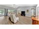 Living room featuring vaulted ceiling, wood flooring, and a comfortable seating arrangement at 5705 Garden Lakes Majestic, Bradenton, FL 34203