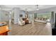 This open living area features wood flooring, easy access to other rooms, and modern furnishings at 5705 Garden Lakes Majestic, Bradenton, FL 34203