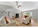 The open living room features lots of space, with wood flooring, bay windows, and a vaulted ceiling at 5705 Garden Lakes Majestic, Bradenton, FL 34203