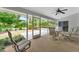 Spacious screened patio featuring outdoor seating with a view of the yard at 5705 Garden Lakes Majestic, Bradenton, FL 34203