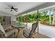 Screened patio area with ceiling fan and comfortable seating, perfect for outdoor relaxation at 5705 Garden Lakes Majestic, Bradenton, FL 34203