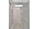 Shower with glass doors and gray marble-look tiles at 5705 Garden Lakes Majestic, Bradenton, FL 34203