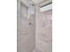 Shower stall featuring marble-look tile and recessed shelving at 5705 Garden Lakes Majestic, Bradenton, FL 34203