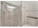 Walk-in shower featuring marble-look tile and built-in seating at 5705 Garden Lakes Majestic, Bradenton, FL 34203