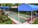 Community shuffleboard courts with covered seating amidst lush greenery, perfect for friendly competition and relaxation at 5705 Garden Lakes Majestic, Bradenton, FL 34203
