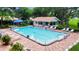 Bright community pool featuring a spacious sun deck with ample seating and a covered pool-side shelter at 5705 Garden Lakes Majestic, Bradenton, FL 34203