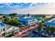 Aerial view of quaint beach community with brightly painted stores, restaurants, and tropical landscaping at 6012 11Th W Ave, Bradenton, FL 34209