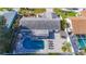 Aerial view of the property features a backyard with a pool, lounge chairs, and a stylish pergola at 6012 11Th W Ave, Bradenton, FL 34209