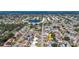 Aerial view of a vibrant residential neighborhood features mature trees, a lake, and well-maintained homes at 6012 11Th W Ave, Bradenton, FL 34209