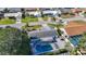 Property aerial view with a backyard featuring a refreshing pool, lounge area and stylish pergola at 6012 11Th W Ave, Bradenton, FL 34209