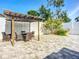 Enjoy outdoor gatherings under a shaded pergola with dining set, all set on a nicely paved stone backyard at 6012 11Th W Ave, Bradenton, FL 34209