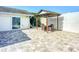 Backyard patio with dining set under a pergola, featuring pavers and full fencing at 6012 11Th W Ave, Bradenton, FL 34209