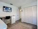 This bedroom has wood floors, a closet, and a desk with a tv mounted on the wall at 6012 11Th W Ave, Bradenton, FL 34209