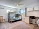Comfortable bedroom with a bunk bed, dedicated workspace, and overhead storage at 6012 11Th W Ave, Bradenton, FL 34209