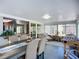 Bright dining room featuring a large table, access to the kitchen and backyard at 6012 11Th W Ave, Bradenton, FL 34209