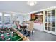 Bright dining area featuring a foosball table, pass-through to kitchen, and patio access at 6012 11Th W Ave, Bradenton, FL 34209