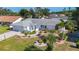 Charming property showcases neat landscaping, mature palm trees, and a beautifully maintained white exterior at 6012 11Th W Ave, Bradenton, FL 34209