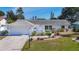 Charming single-story home with a well-manicured lawn, fresh landscaping, and an attached two-car garage at 6012 11Th W Ave, Bradenton, FL 34209