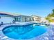Backyard pool with sun loungers, seating area, and enclosed patio at 6012 11Th W Ave, Bradenton, FL 34209