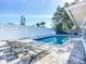 Relaxing pool area features a sparkling in-ground pool, paved deck and multiple lounge chairs for relaxing in the sun at 6012 11Th W Ave, Bradenton, FL 34209