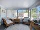Bright sunroom with wicker furniture and views of the backyard and patio at 6012 11Th W Ave, Bradenton, FL 34209