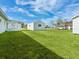 This backyard includes a well-maintained lawn and a shed, and the main house with a screened in porch at 6116 Rodgers Ave, Sarasota, FL 34231