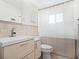 Updated bathroom featuring modern vanity, decorative tiling, and shower with neutral curtain at 6116 Rodgers Ave, Sarasota, FL 34231
