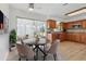 Eat-in kitchen with modern appliances, wood cabinets, and bright dining area at 6116 Rodgers Ave, Sarasota, FL 34231