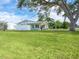 A well-maintained single-story home featuring a spacious lawn and a privacy fence at 6116 Rodgers Ave, Sarasota, FL 34231