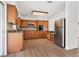 The well-lit kitchen boasts wood cabinetry, stainless steel appliances, and a practical layout for cooking at 6116 Rodgers Ave, Sarasota, FL 34231