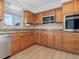 This well-equipped kitchen features wood cabinets, stainless steel appliances, and durable countertops at 6116 Rodgers Ave, Sarasota, FL 34231