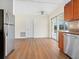 This kitchen features an open layout with wood cabinetry, stainless steel appliances, and sliding glass doors to outdoors at 6116 Rodgers Ave, Sarasota, FL 34231