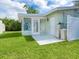 Back patio area leading to a Florida room, offering a cozy outdoor living space at 6116 Rodgers Ave, Sarasota, FL 34231
