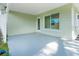 This back patio offers a serene outdoor space with a door to the backyard and a large window at 6116 Rodgers Ave, Sarasota, FL 34231